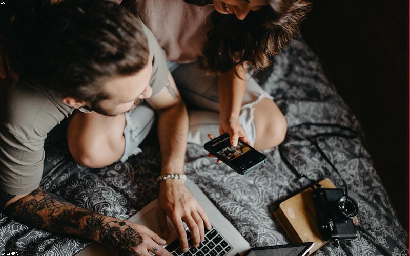 Couple reviewing relocation data on laptop